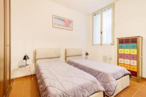 Posteľ alebo postele v izbe v ubytovaní Torre dell'Orologio Apartment