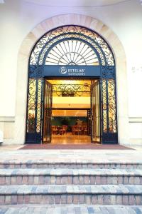 an entrance to a restaurant with stairs in front at Hotel Estelar Suites Jones in Bogotá