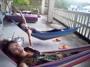 a young boy laying in a hammock at backpackers guesthouse Border in Nago