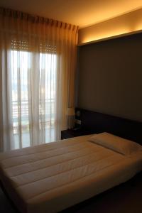 a bedroom with a large bed with a window at Albergo Miramonti in Potenza