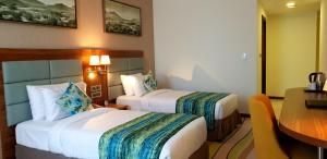 Rúm í herbergi á Jacob's Garden Hotel
