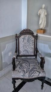 a chair with a statue of a woman on a shelf at Villa Andromeda in Chania