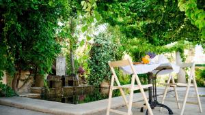 two chairs and a table in front of a garden at Villa Andromeda in Chania