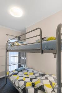 a bedroom with two bunk beds and a window at Esperance Bay Holiday Park in Esperance