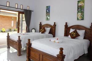 Postel nebo postele na pokoji v ubytování Sekumpul Accommodation
