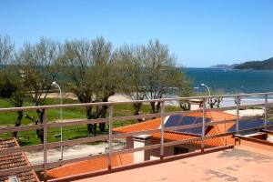 a balcony with a view of the water at Playa América Angelito A in Playa América