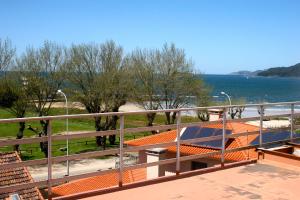 a balcony with a view of the water at Apartamentos Angelito in Playa América