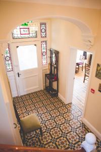 a hallway with a room with a door and a chair at Glencoe Villa Guesthouse in Featherstone