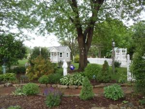 a garden in front of a white fence at The Carriage House on Slope Hill in Mount Pleasant