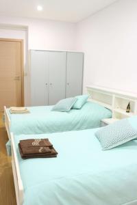 - une chambre avec 2 lits avec des draps bleus dans l'établissement Conforto em Fátima, à Fátima