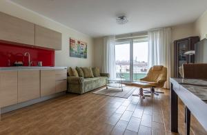 a kitchen and living room with a couch and a table at Apartament Brandy in Szczecin