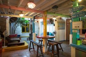 a restaurant with a table and chairs in a room at Gili La Boheme in Gili Trawangan