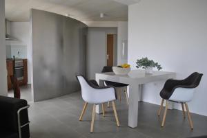 a kitchen and dining room with a white table and chairs at VILLA HORIZONTE in Puntagorda