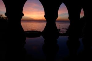 a view of the sunset from the ruins of a building at Hotel Villa Margherita in Quercianella