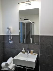 a bathroom with a white sink and a mirror at Hotel Panorama in Chianciano Terme +22 photos