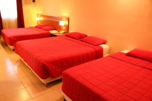 Giường trong phòng chung tại Olimpo Hotel & Suites