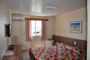 a hotel room with a bed and a window at Hotel Casa De Praia in Fortaleza +23 photos