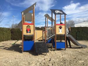a playground with a slide in the sand at Camping Caravaning Les Cerisiers Berck sur mer in Verton