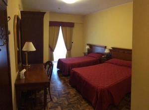 Postel nebo postele na pokoji v ubytování Albergo Ristorante Uliveto