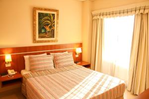 Giường trong phòng chung tại Olimpo Hotel & Suites