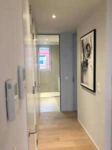 a hallway with a door leading to a bathroom at Skyline Flats Gent in Ghent +94 photos