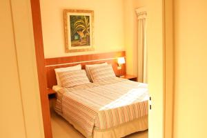 Giường trong phòng chung tại Olimpo Hotel & Suites