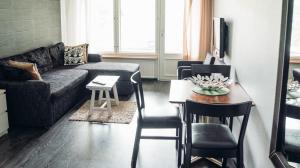 a living room with a couch and a table at Ukko in Tahkovuori