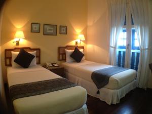 Llit o llits en una habitació de Perak Hotel
