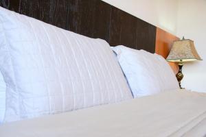 Giường trong phòng chung tại Olimpo Hotel & Suites