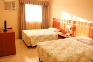 Giường trong phòng chung tại Olimpo Hotel & Suites