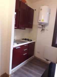 a small kitchen with brown cabinets and a sink at Casa Belzoni in Padova