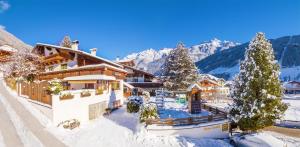 a ski lodge in the mountains in the snow at Pension Sonnleitn in Neustift im Stubaital