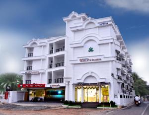 a white building with a store in front of it at Hotel Vashanth Krishna in Nāgercoil