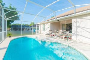 a swimming pool in the backyard of a house at Orlando Mouse Manor in Davenport