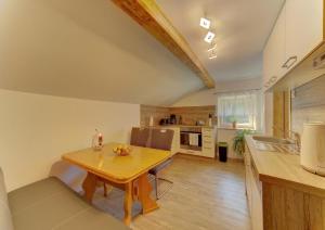 a kitchen and dining room with a wooden table at Panoramablick in Mauth