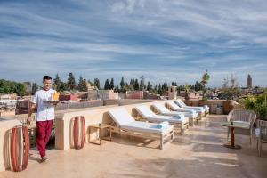 a man standing on the roof of a building at 72 Riad Living in Marrakesh