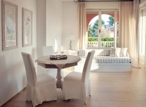 een woonkamer met een tafel en stoelen en een bank bij Villa Telli in Garda