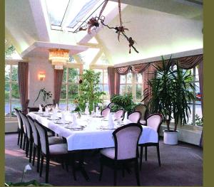 Hotel Waldquelle في أوريتش: غرفة طعام كبيرة مع طاولة وكراسي طويلة