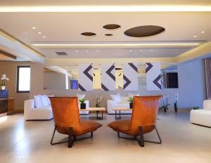 un hall avec des canapés et des chaises dans un bâtiment dans l'établissement Ikones Seafront Luxury Suites, à Réthymnon