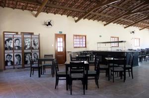 a dining room with tables and chairs in a building at Pousada Rural Águas da Prata in Águas da Prata