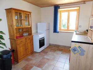 a kitchen with a white refrigerator and a sink at Gîte Le Corral in Cheminas