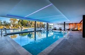 a large swimming pool with a blue ceiling at Barceló Sevilla Renacimiento in Seville +84 photos