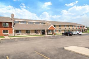 a parking lot in front of a large building at AmericInn by Wyndham Elkhorn Near Lake Geneva in Elkhorn