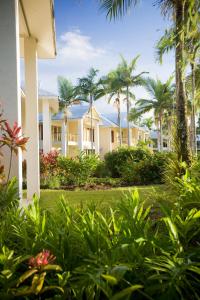 a large garden with trees and a house at Paradise Links Resort Port Douglas in Port Douglas