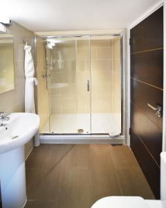 a bathroom with a shower and a sink at Duke Of Normandie in St Peter Port