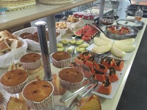 un buffet lleno de diferentes tipos de comida a la vista en Hotel Village Campinas en Campinas