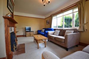 a living room with a couch and a table at 4 Brooks Close in Bembridge