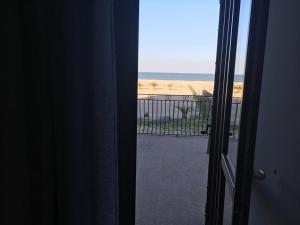 a view of the beach from the door of a room at Traiano Suite in Margherita di Savoia