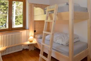 Postel nebo postele na pokoji v ubytování Andalo Chalet