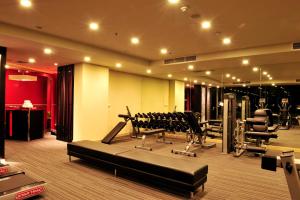 a gym with treadmills and machines in a room at Amaranth Suvarnabhumi Hotel in Lat Krabang